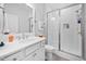 Pristine bathroom with glass enclosed shower, vanity, and white subway tile at 2109 Flycatcher Ln, Fuquay Varina, NC 27526