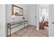 Inviting foyer with hardwood floors, console table and a decorative rug at 2109 Flycatcher Ln, Fuquay Varina, NC 27526