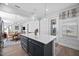 Open concept kitchen with an island, pendant lights, and a view into the dining and living areas at 2109 Flycatcher Ln, Fuquay Varina, NC 27526