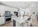 Modern kitchen with stainless steel appliances, a center island, and stylish pendant lighting at 2109 Flycatcher Ln, Fuquay Varina, NC 27526