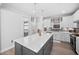 Contemporary kitchen featuring a large island with seating and modern white cabinetry at 2109 Flycatcher Ln, Fuquay Varina, NC 27526