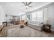 Spacious open-concept living room with a ceiling fan, wood floors and a connecting kitchen at 2109 Flycatcher Ln, Fuquay Varina, NC 27526