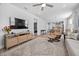 Bright open-concept living room featuring wood floors, a ceiling fan and comfortable seating at 2109 Flycatcher Ln, Fuquay Varina, NC 27526