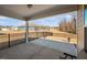 Covered patio featuring a black metal fence and view of neighboring properties at 2109 Flycatcher Ln, Fuquay Varina, NC 27526
