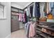 Well-organized walk-in closet with custom shelving, drawers, rods, and ample storage space for clothes and accessories at 2109 Flycatcher Ln, Fuquay Varina, NC 27526