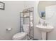 Cozy half bathroom features a pedestal sink and decor at 234 Palmetto Tree Way, Knightdale, NC 27545