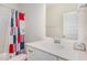 Bathroom features a shower-tub combo and modern sink at 234 Palmetto Tree Way, Knightdale, NC 27545