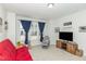 Bedroom with carpeted floors, neutral color, window with curtain and mounted TV at 234 Palmetto Tree Way, Knightdale, NC 27545