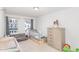 Bedroom with a crib, dresser, and couch at 234 Palmetto Tree Way, Knightdale, NC 27545