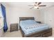 Bedroom showcases a bed with blue bedding, bedside tables, and natural light at 234 Palmetto Tree Way, Knightdale, NC 27545
