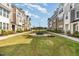 Townhome community with sidewalks, green space, and well-maintained landscaping at 234 Palmetto Tree Way, Knightdale, NC 27545