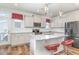Charming kitchen features granite counters, stainless appliances, an island, and access to the backyard at 234 Palmetto Tree Way, Knightdale, NC 27545