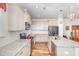 Open kitchen boasts granite counters, stainless appliances, and white cabinets at 234 Palmetto Tree Way, Knightdale, NC 27545