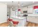 Kitchen with granite counters, white cabinets, stainless appliances and island with bar seating at 234 Palmetto Tree Way, Knightdale, NC 27545