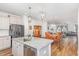 Open kitchen features granite counters and stainless appliances that flows into the dining and living areas at 234 Palmetto Tree Way, Knightdale, NC 27545