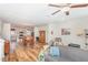 Open-concept living area with hardwood floors that seamlessly connects to kitchen at 234 Palmetto Tree Way, Knightdale, NC 27545