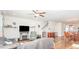 Bright living room featuring a fireplace, ceiling fan, and open access to the dining area and staircase at 234 Palmetto Tree Way, Knightdale, NC 27545