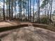 View of the backyard featuring a brick patio and wooded surroundings at 241 Beachers Brook Ln, Cary, NC 27511