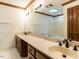 Bathroom featuring double sink vanity, large mirror, and a tub/shower at 241 Beachers Brook Ln, Cary, NC 27511