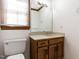 Bathroom with wood vanity, marble countertop, a large mirror, and window at 241 Beachers Brook Ln, Cary, NC 27511