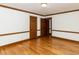Bedroom featuring hardwood floors, white walls with wood trim and interior doors at 241 Beachers Brook Ln, Cary, NC 27511