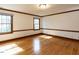 Bedroom featuring hardwood floors and two bright windows at 241 Beachers Brook Ln, Cary, NC 27511