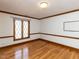 Bedroom with hardwood floors, white walls with wood trim, ceiling light, and window at 241 Beachers Brook Ln, Cary, NC 27511