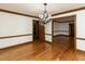 Dining room features hardwood floors, chandelier, and wood trim at 241 Beachers Brook Ln, Cary, NC 27511