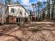 Exterior shot of the home with a brick and siding, sunroom, and wooded backyard at 241 Beachers Brook Ln, Cary, NC 27511