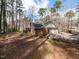 Exterior side view of the home showing the garage and surrounding woods at 241 Beachers Brook Ln, Cary, NC 27511