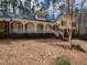 Charming yellow home with a welcoming porch, white railings, and mature trees at 241 Beachers Brook Ln, Cary, NC 27511