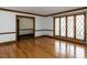 Bright living room with hardwood floors, large windows, and wood trim details at 241 Beachers Brook Ln, Cary, NC 27511