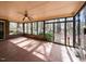 Enclosed sunroom with tiled floor and multiple windows offering outdoor views at 241 Beachers Brook Ln, Cary, NC 27511