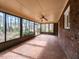 Enclosed sunroom with tiled floor and multiple windows offering outdoor views at 241 Beachers Brook Ln, Cary, NC 27511