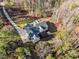 Aerial view of property featuring an expansive lot with lush trees and a private backyard at 290 Whistlers Cv, Louisburg, NC 27549