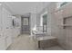 Bright bathroom featuring double vanity, soaking tub, and glass shower at 290 Whistlers Cv, Louisburg, NC 27549