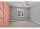 Spacious bedroom featuring a trendy accent wall, plush carpet, and large windows at 290 Whistlers Cv, Louisburg, NC 27549