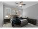 Cozy bedroom featuring patterned wallpaper, unique artwork, and windows at 290 Whistlers Cv, Louisburg, NC 27549