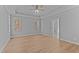 Bright bedroom featuring a tray ceiling and large windows at 290 Whistlers Cv, Louisburg, NC 27549