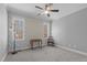 Bedroom featuring patterned wallpaper and serene wooded views from the windows at 290 Whistlers Cv, Louisburg, NC 27549