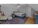 Cozy bedroom with hardwood flooring, ceiling fan, and area rug at 290 Whistlers Cv, Louisburg, NC 27549