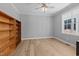 Bright bedroom with natural light, hardwood flooring, and a built-in bookshelf at 290 Whistlers Cv, Louisburg, NC 27549