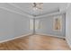 Open and bright bedroom with tray ceiling and large windows that provide plenty of natural light at 290 Whistlers Cv, Louisburg, NC 27549