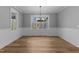 Dining room showcasing wainscotting, wood flooring, and abundant natural light at 290 Whistlers Cv, Louisburg, NC 27549