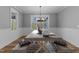 Dining room featuring a trestle table with benches and a modern chandelier at 290 Whistlers Cv, Louisburg, NC 27549