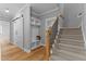 Entryway featuring wood flooring, storage cubbies, sliding barn door, and stairs at 290 Whistlers Cv, Louisburg, NC 27549