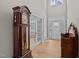 Elegant foyer featuring hardwood floors, high ceilings, a beautiful front door, and vintage decor at 290 Whistlers Cv, Louisburg, NC 27549