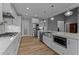 Bright kitchen with a large island, stainless steel appliances, and wood flooring at 290 Whistlers Cv, Louisburg, NC 27549