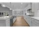 Bright, open kitchen design with a large island and stainless steel appliances at 290 Whistlers Cv, Louisburg, NC 27549