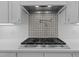 Close-up of a modern gas range and mosaic tile backsplash in a bright kitchen at 290 Whistlers Cv, Louisburg, NC 27549